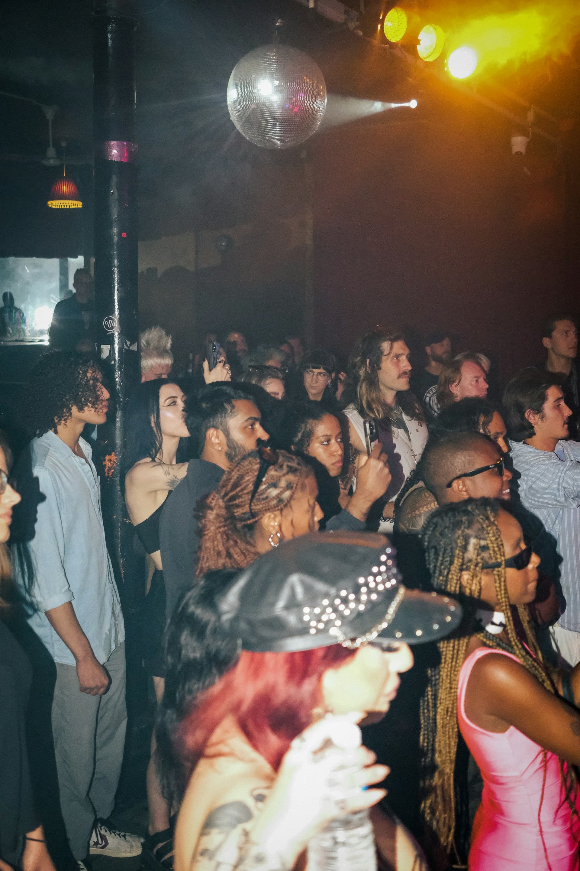 Diverse urban crowd at a nightclub — people from all backgrounds, dressed up and celebrating