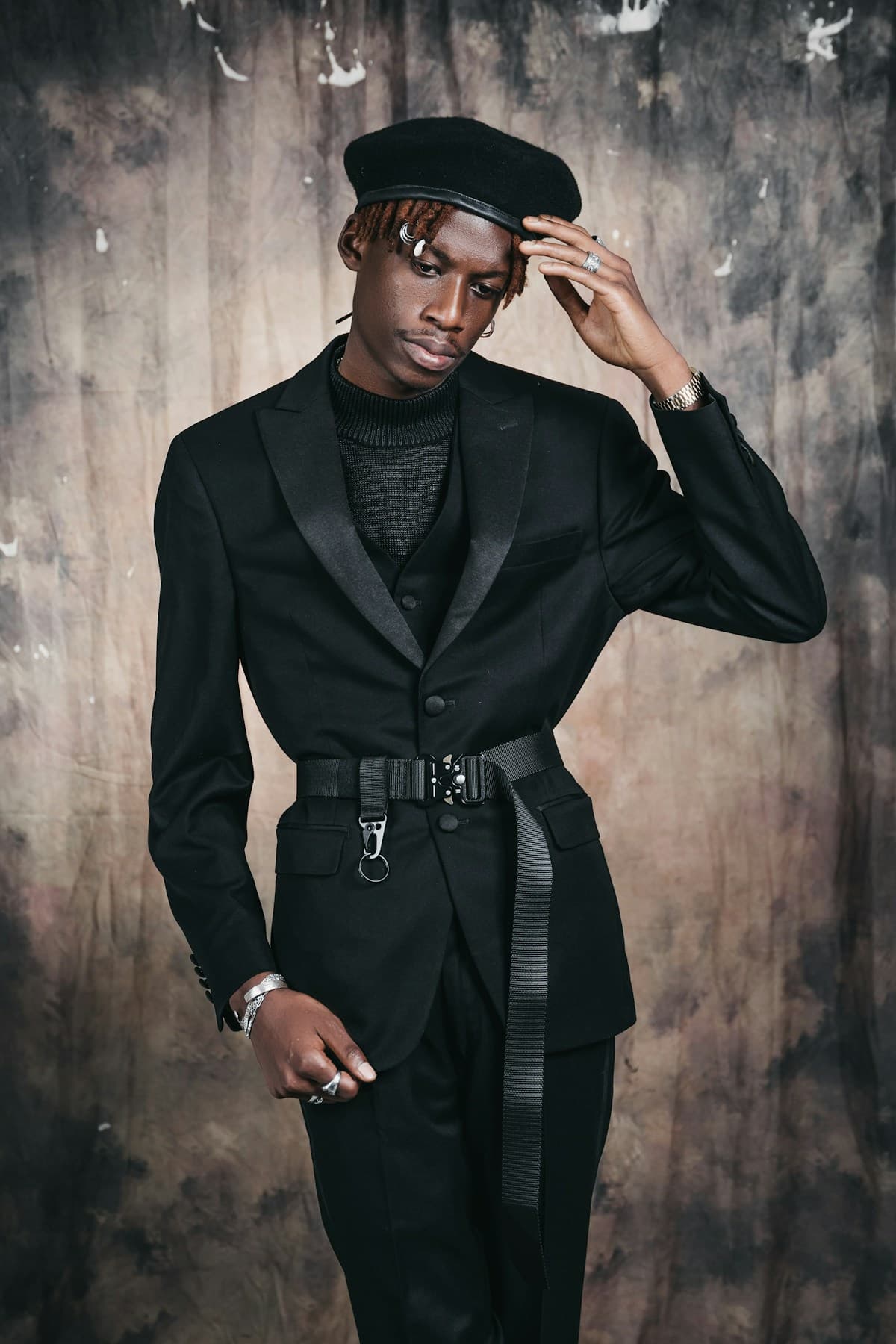 Young man in belted suit and beret