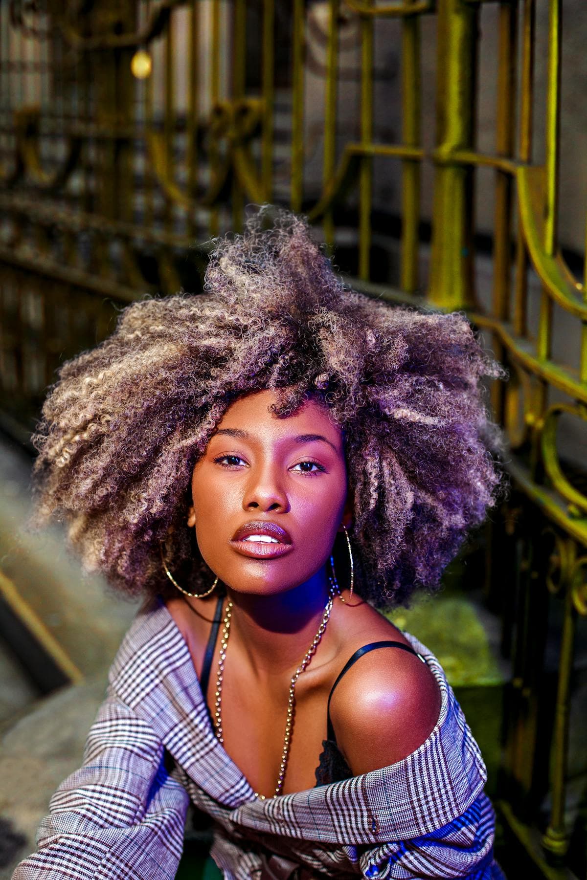 Woman with natural afro, urban industrial backdrop