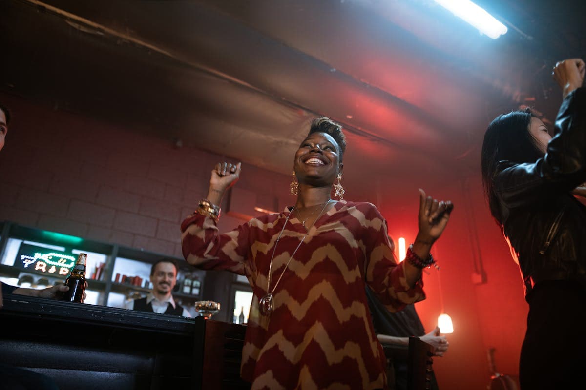 Woman dancing with joy at a bar