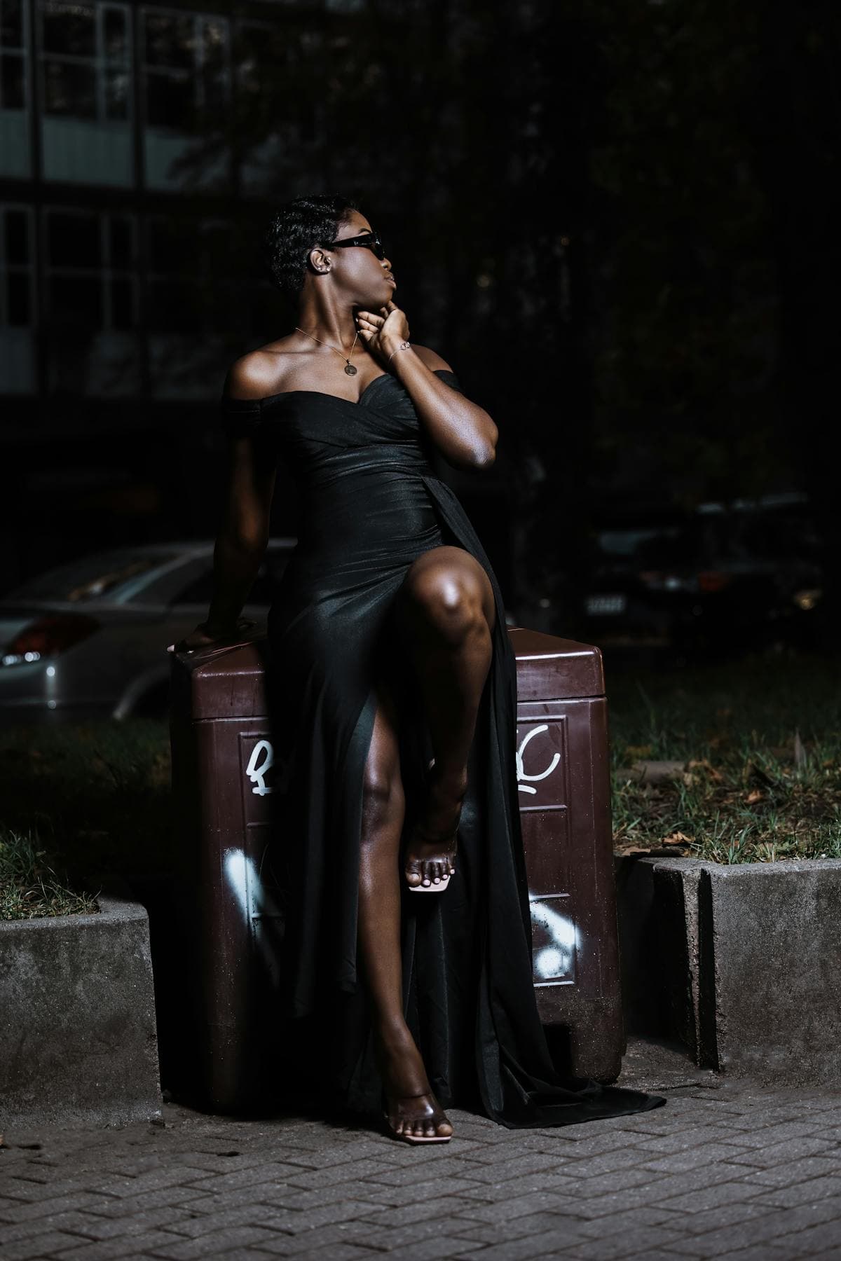 Woman in elegant off-shoulder gown at night